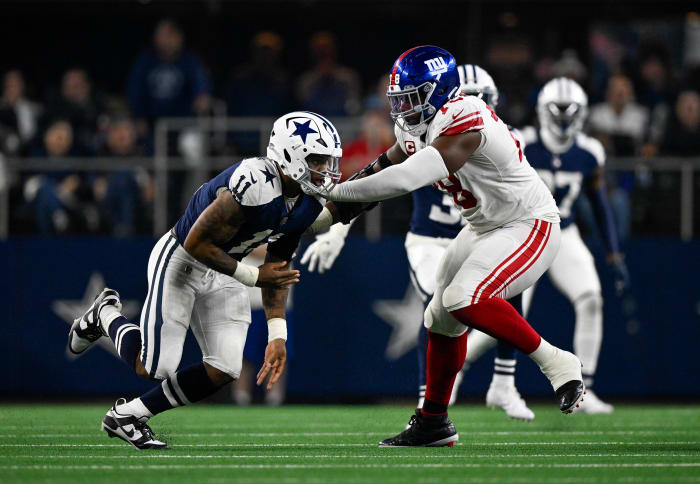 New York Giants offensive tackle Andrew Thomas puts his hands out to try to block Dallas Cowboys linebacker Micah Parsons